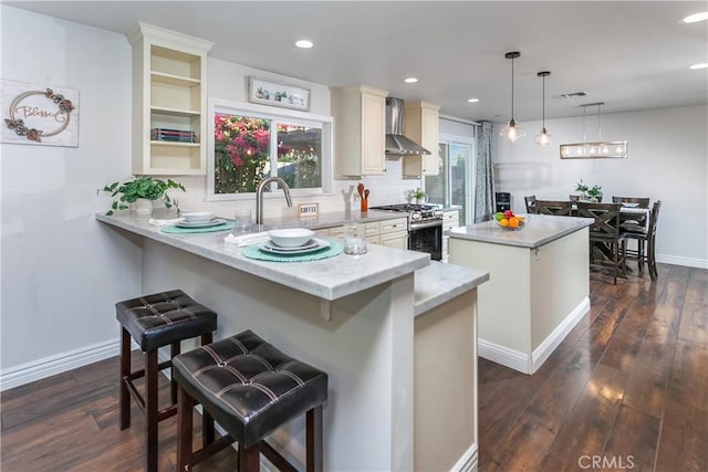 3640 Rosalie St, Simi Valley, CA 93063 - kitchen with gas stove, wall chimney range hood, a center island, dark wood-style flooring, and tasteful backsplash