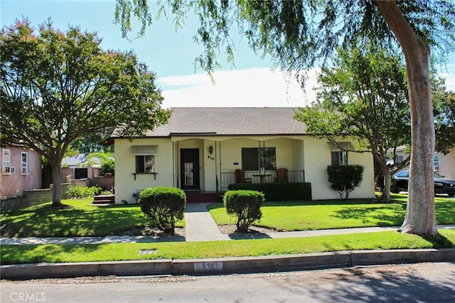 836 N 10th Ave, Upland, CA 91786 - view of front of house with stucco siding, a front lawn, covered porch, and roof with shingles