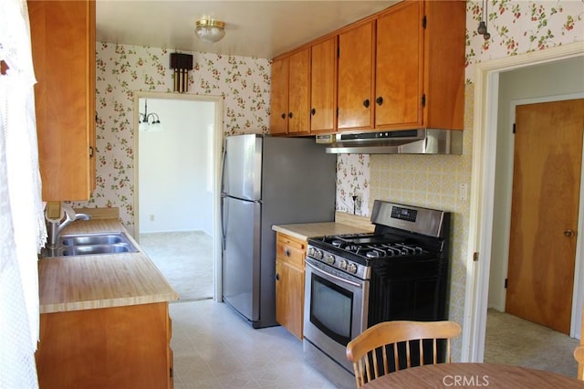 836 N 10th Ave, Upland, CA 91786 - kitchen featuring stainless steel appliances, under cabinet range hood, wallpapered walls, light countertops, and light floors