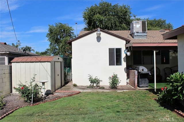 836 N 10th Ave, Upland, CA 91786 - rear view of house featuring a storage shed, a yard, roof with shingles, and stucco siding