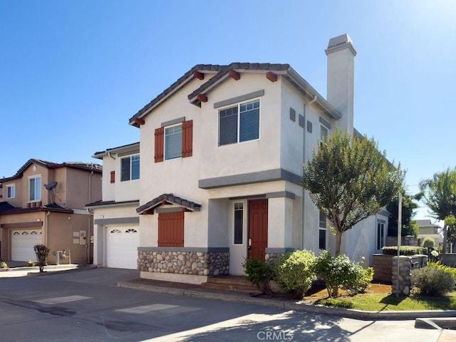 5612 Sprague Ave, Cypress, CA 90630 - view of front of home with an attached garage, stucco siding, concrete driveway, and a chimney