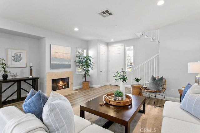 5612 Sprague Ave, Cypress, CA 90630 - living room with stairs, recessed lighting, healthy amount of natural light, light wood-style floors, and a premium fireplace