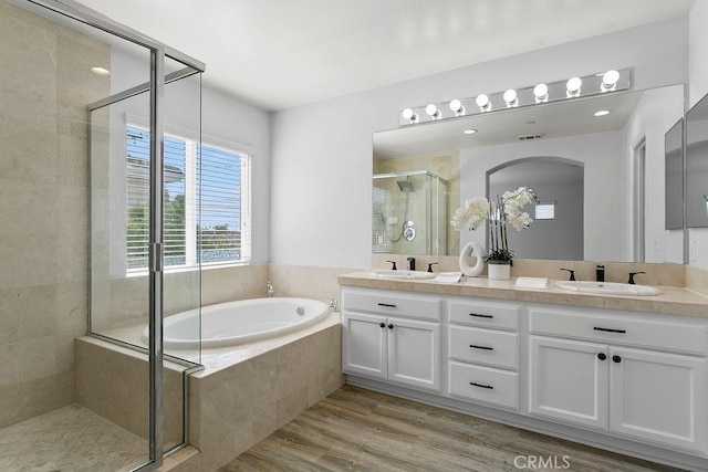 5612 Sprague Ave, Cypress, CA 90630 - full bath featuring a stall shower, double vanity, a garden tub, and wood finished floors