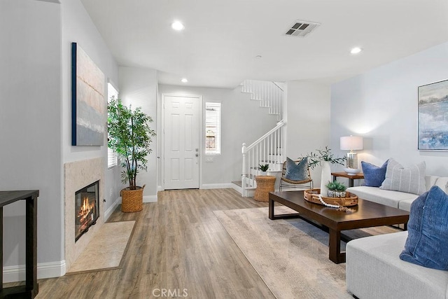 5612 Sprague Ave, Cypress, CA 90630 - living area featuring light wood-style flooring, stairs, recessed lighting, and a premium fireplace