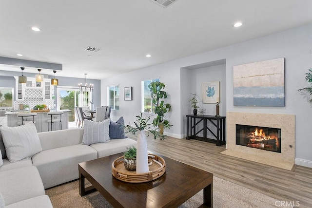 5612 Sprague Ave, Cypress, CA 90630 - living room with wood finished floors, recessed lighting, a chandelier, and a high end fireplace