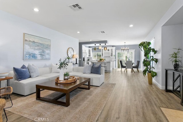 5612 Sprague Ave, Cypress, CA 90630 - living area with light wood-style floors, a chandelier, and recessed lighting
