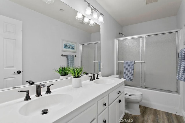 5612 Sprague Ave, Cypress, CA 90630 - bathroom featuring double vanity, wood finished floors, and shower / bath combination with glass door