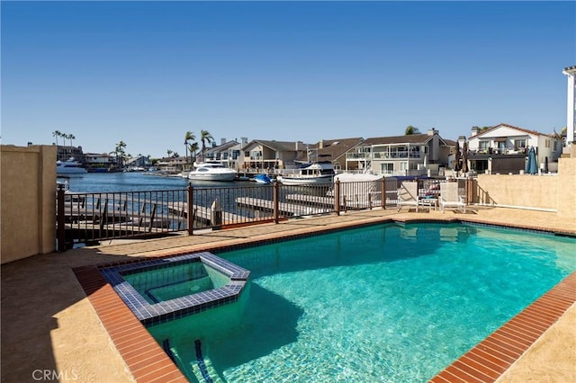 3871 Mistral Dr, Huntington Beach, CA 92649 - view of pool with a pool with connected hot tub, a residential view, a fenced backyard, and a water view