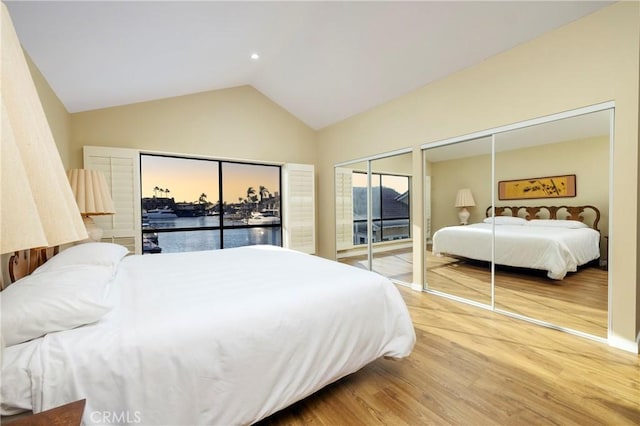 3871 Mistral Dr, Huntington Beach, CA 92649 - bedroom featuring wood finished floors, two closets, lofted ceiling, and access to exterior