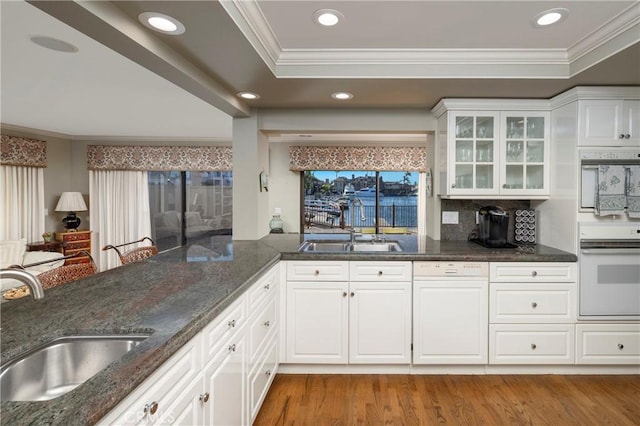 3871 Mistral Dr, Huntington Beach, CA 92649 - kitchen featuring glass insert cabinets, dark stone countertops, wood finished floors, crown molding, and white cabinets
