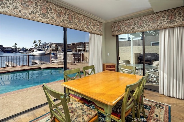 3871 Mistral Dr, Huntington Beach, CA 92649 - dining space featuring crown molding, wood finished floors, and a water view