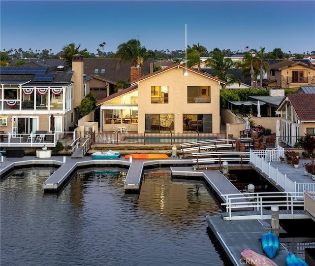 3871 Mistral Dr, Huntington Beach, CA 92649 - back of house featuring a water view, a fenced backyard, and a residential view