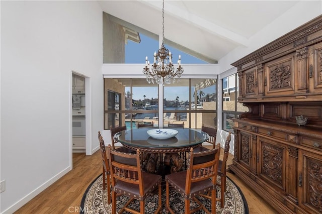 3871 Mistral Dr, Huntington Beach, CA 92649 - dining room featuring a chandelier, beam ceiling, light wood-type flooring, and high vaulted ceiling