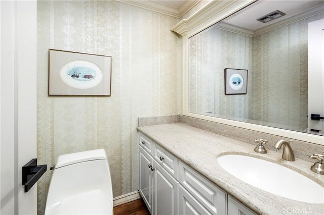 3871 Mistral Dr, Huntington Beach, CA 92649 - half bath featuring wallpapered walls, vanity, wood finished floors, and crown molding