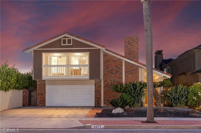 3871 Mistral Dr, Huntington Beach, CA 92649 - view of front of house featuring brick siding, concrete driveway, a garage, and a chimney