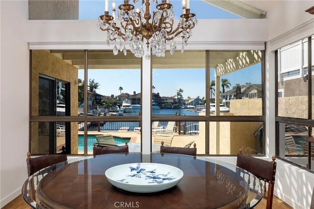 3871 Mistral Dr, Huntington Beach, CA 92649 - dining room with a chandelier, plenty of natural light, a water view, and wood finished floors