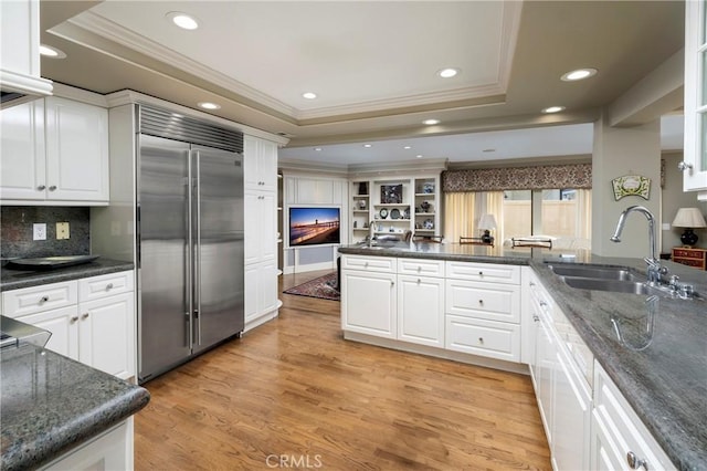 3871 Mistral Dr, Huntington Beach, CA 92649 - kitchen featuring stainless steel built in fridge, a tray ceiling, crown molding, white cabinetry, and light wood-type flooring