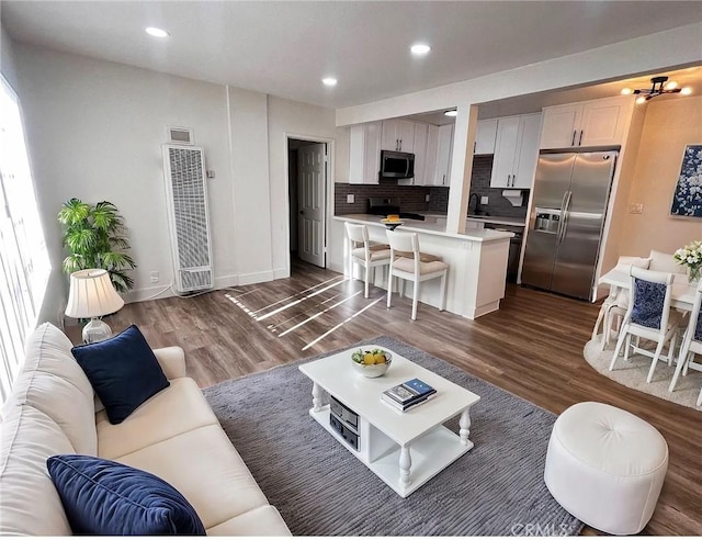 10802 Palma Vista Ave, Garden Grove, CA 92840 - living room featuring a heating unit, dark wood-style flooring, and recessed lighting