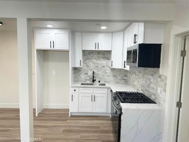 10802 Palma Vista Ave, Garden Grove, CA 92840 - kitchen featuring stainless steel appliances, light wood finished floors, white cabinetry, backsplash, and recessed lighting