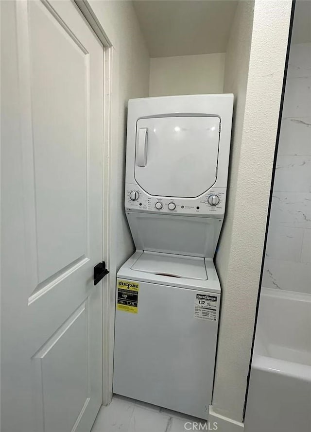 10802 Palma Vista Ave, Garden Grove, CA 92840 - washroom with estacked washer and dryer and light marble finish floors