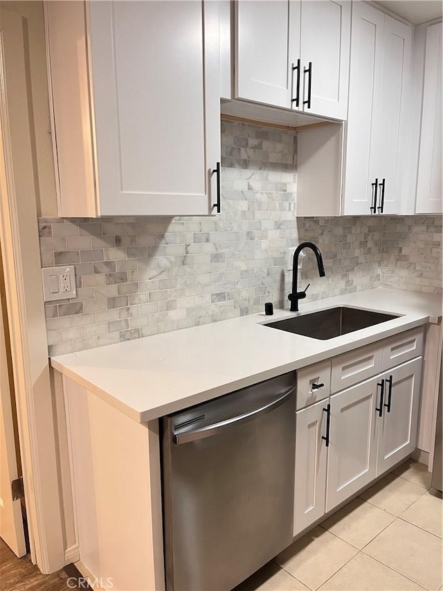 10802 Palma Vista Ave, Garden Grove, CA 92840 - kitchen with dishwasher, light countertops, backsplash, white cabinets, and light tile patterned floors