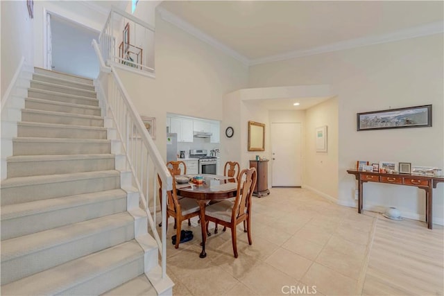 2201 Dublin Ln Unit 3, Diamond Bar, CA 91765 - dining room with crown molding, stairway, light tile patterned floors, and a towering ceiling