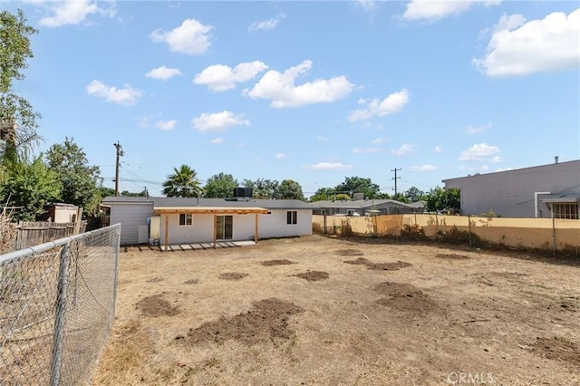 530 E 3rd St, Rialto, CA 92376 - back of house with a fenced backyard and a patio