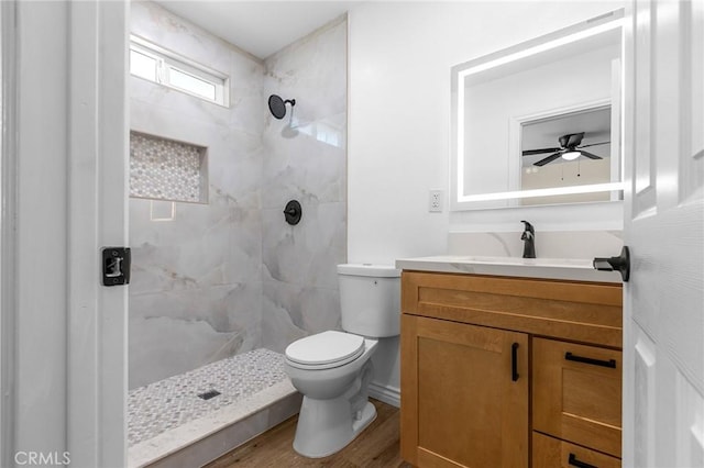530 E 3rd St, Rialto, CA 92376 - bathroom with a tile shower, vanity, wood finished floors, and ceiling fan