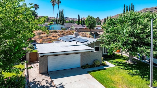 29639 Delphinium Ave, Canyon Country, CA 91387 - view of front of house with roof mounted solar panels, stucco siding, driveway, and an attached garage