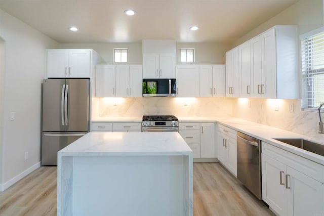 1295 Haglar Unit 1, Chula Vista, CA 91913 - kitchen featuring stainless steel appliances, a center island, light wood-style floors, tasteful backsplash, and recessed lighting