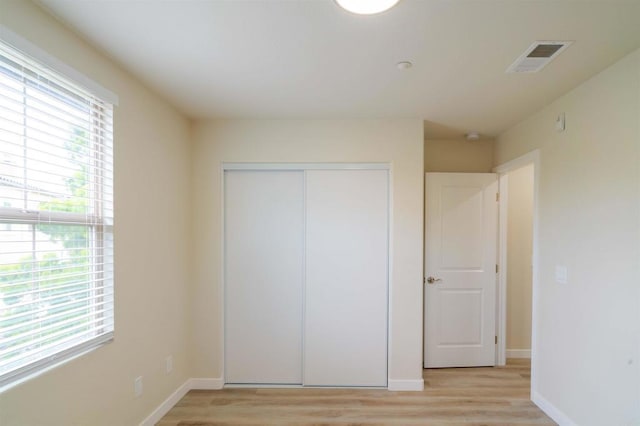 1295 Haglar Unit 1, Chula Vista, CA 91913 - unfurnished bedroom featuring light wood-type flooring and a closet