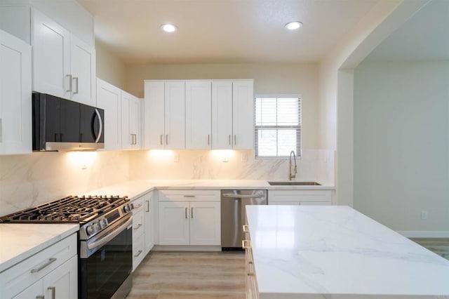 1295 Haglar Unit 1, Chula Vista, CA 91913 - kitchen featuring appliances with stainless steel finishes, light stone counters, white cabinetry, and recessed lighting