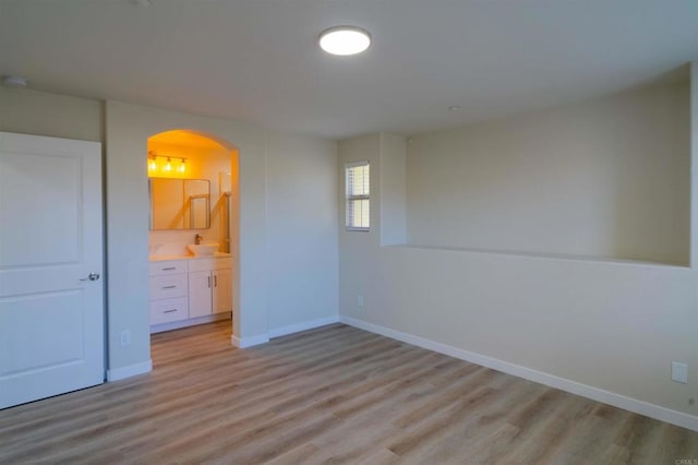 1295 Haglar Unit 1, Chula Vista, CA 91913 - unfurnished bedroom with arched walkways, light wood finished floors, and ensuite bath