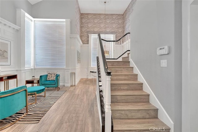 16549 Celadon Ct, Chino Hills, CA 91709 - stairs featuring wood finished floors, a decorative wall, and wainscoting