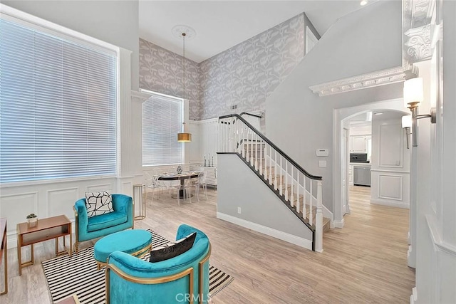 16549 Celadon Ct, Chino Hills, CA 91709 - sitting room featuring stairs, arched walkways, a wainscoted wall, wood finished floors, and wallpapered walls