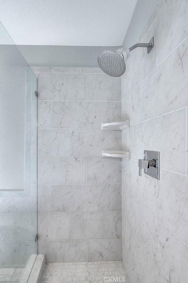 16549 Celadon Ct, Chino Hills, CA 91709 - bathroom featuring tiled shower and a textured ceiling