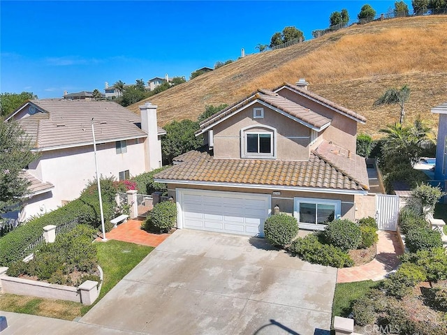 16549 Celadon Ct, Chino Hills, CA 91709 - traditional home with a gate, a tiled roof, driveway, and stucco siding