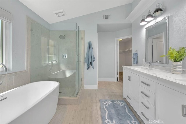 16549 Celadon Ct, Chino Hills, CA 91709 - bathroom featuring a freestanding bath, wood finished floors, a shower stall, vanity, and vaulted ceiling