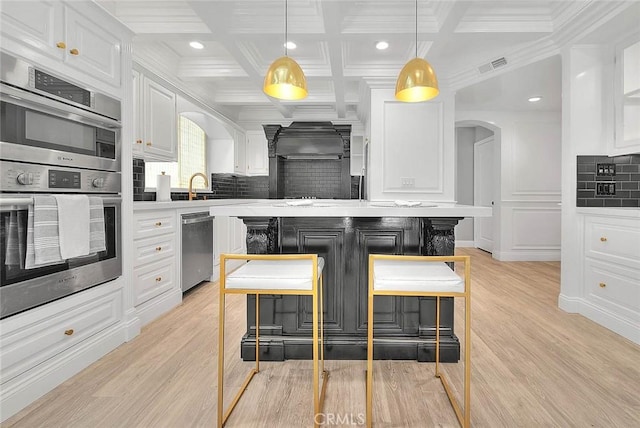16549 Celadon Ct, Chino Hills, CA 91709 - kitchen featuring stainless steel appliances, arched walkways, tasteful backsplash, white cabinetry, and recessed lighting