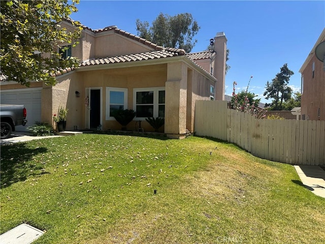 10600 Silverleaf Cir, Moreno Valley, CA 92557 - view of front of home featuring a tiled roof, stucco siding, a chimney, and an attached garage