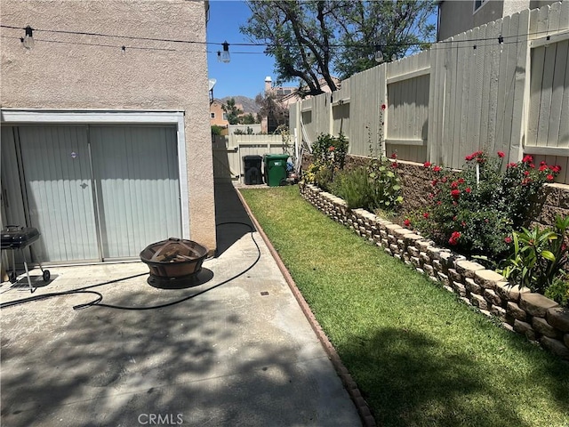 10600 Silverleaf Cir, Moreno Valley, CA 92557 - fenced backyard with a patio and a fire pit