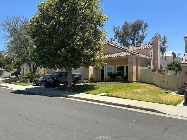 10600 Silverleaf Cir, Moreno Valley, CA 92557 - view of front facade with stucco siding, a tile roof, a garage, and driveway