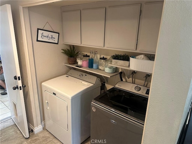 10600 Silverleaf Cir, Moreno Valley, CA 92557 - washroom with washing machine and clothes dryer, cabinet space, and light tile patterned floors