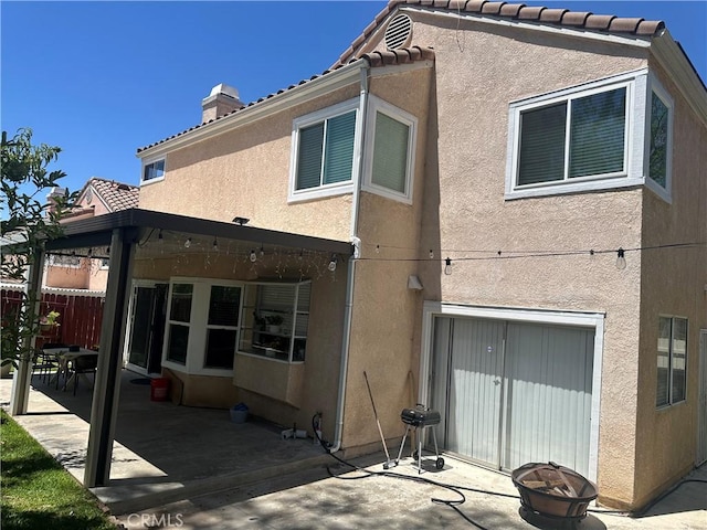 10600 Silverleaf Cir, Moreno Valley, CA 92557 - rear view of house with a patio, stucco siding, a chimney, and a tile roof