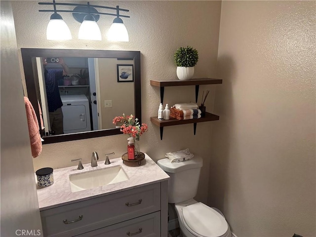 10600 Silverleaf Cir, Moreno Valley, CA 92557 - bathroom with washer / clothes dryer, vanity, and a textured wall