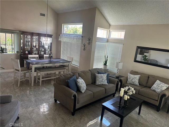 10600 Silverleaf Cir, Moreno Valley, CA 92557 - living area with vaulted ceiling, a textured ceiling, plenty of natural light, a chandelier, and marble finish floors