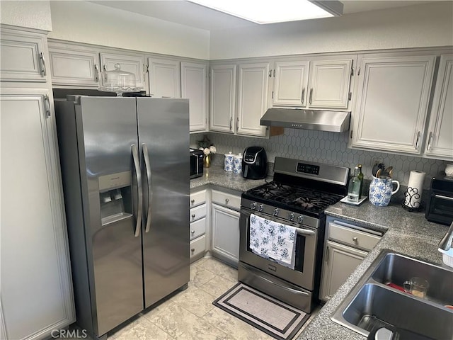 10600 Silverleaf Cir, Moreno Valley, CA 92557 - kitchen with appliances with stainless steel finishes, under cabinet range hood, light tile patterned floors, backsplash, and gray cabinets