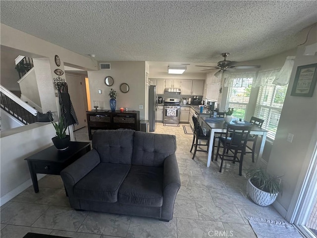 10600 Silverleaf Cir, Moreno Valley, CA 92557 - living area featuring a textured ceiling, ceiling fan, and stairway