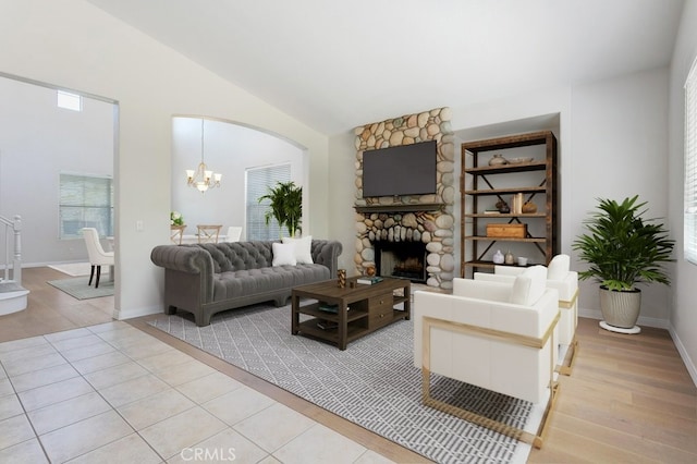 3450 Lake Park Ave, Fallbrook, CA 92028 - living room with plenty of natural light, a chandelier, light wood-style flooring, a stone fireplace, and lofted ceiling
