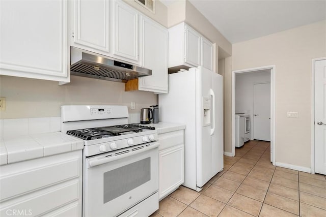 3450 Lake Park Ave, Fallbrook, CA 92028 - kitchen featuring white appliances, exhaust hood, tile counters, separate washer and dryer, and white cabinets